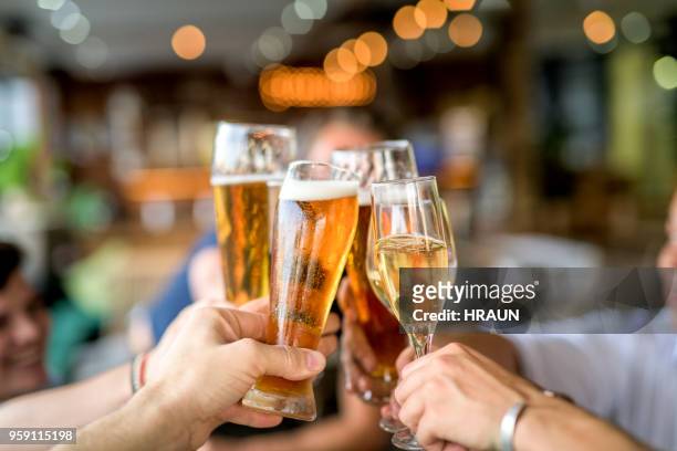 cropped image of friends toasting drinks in celebration. - happy hour stock pictures, royalty-free photos & images