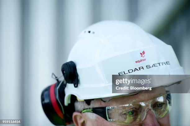 The Equinor ASA logo sits on the hard hat of Eldar Saetre, chief executive officer of Equinor ASA, on board the Troll A natural gas platform,...