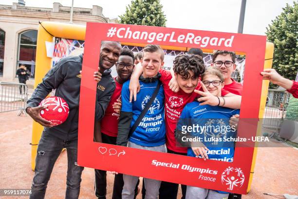 Eric Abidal poses with members of Special Olympics at the Fan Zone ahead of the UEFA Europa League Final between Olympique de Marseille and Club...