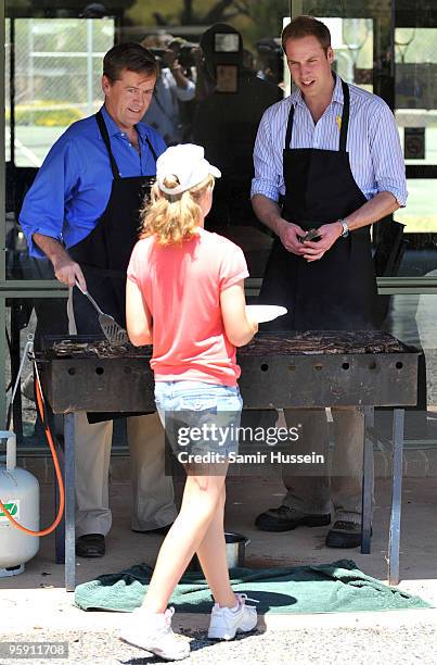 Prince William prepares to serve a girl a BBQ lunch at the Flowerdale community event on the third and final day of his unofficial visit to Australia...