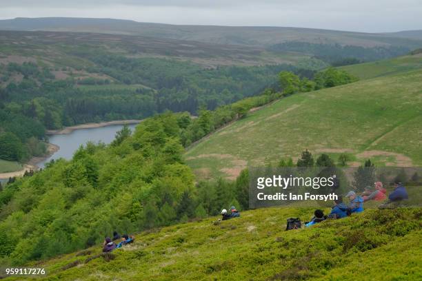 Spectators wait for an RAF Typhoon to fly over the Derwent Dam in the Upper Derwent Valley on May 16, 2018 in Sheffield, England. The Typhoon...