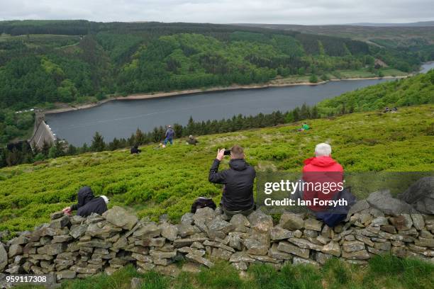 Spectators wait for an RAF Typhoon to fly over the Derwent Dam in the Upper Derwent Valley on May 16, 2018 in Sheffield, England. The Typhoon...