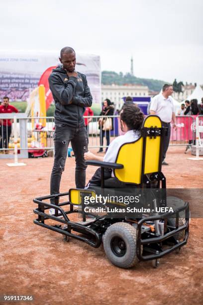 Eric Abidal with a player of the European Powerchair Football Association at the Fan Zone ahead of the UEFA Europa League Final between Olympique de...