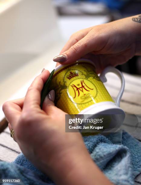 Vicky Bostock applies a lithography on a cup as part of a special collection ahead of the wedding of Prince Harry and Meghan Markle at William...