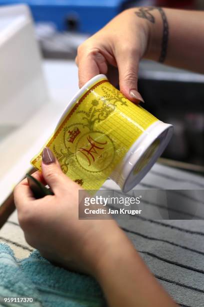 Vicky Bostock applies a lithography on a cup as part of a special collection ahead of the wedding of Prince Harry and Meghan Markle at William...