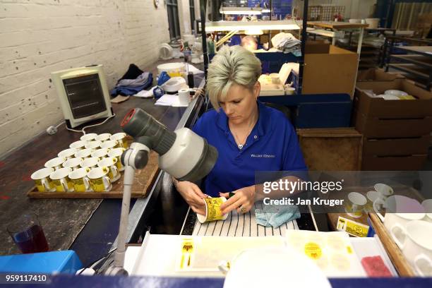 Vicky Bostock applies a lithography on a cup as part of a special collection ahead of the wedding of Prince Harry and Meghan Markle at William...