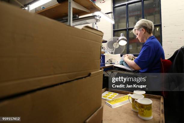 Vicky Bostock applies a lithography on a cup as part of a special collection ahead of the wedding of Prince Harry and Meghan Markle at William...