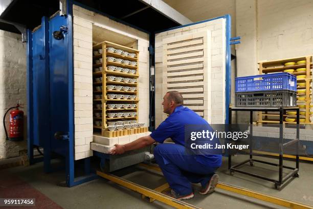 Russel Ellis removes special edition baked tea cups from a kiln ahead of the wedding of Prince Harry and Meghan Markle at William Edwards Home Ltd on...