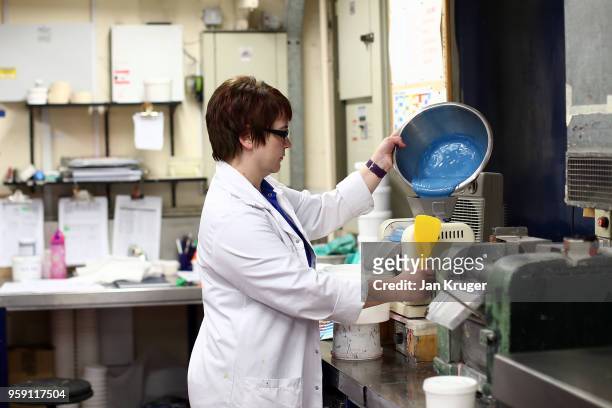Lab Technician Donna Joyson mixes paint for the production of special edition crockery ahead of the wedding of Prince Harry and Meghan Markle at...