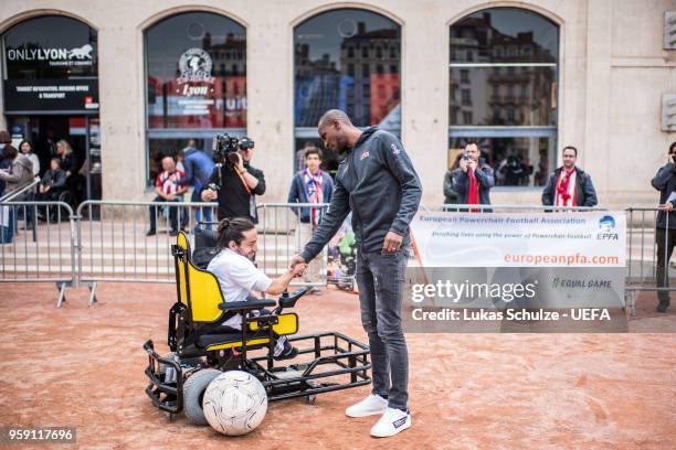 Eric Abidal with a player of the European Powerchair Football Association at the Fan Zone ahead of the UEFA Europa League Final between Olympique de...