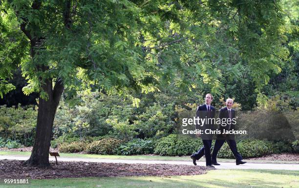 Prince William glances back as he walks by a tree planted by Diana, Princess of Wales in the Botanical Gardens next to Government House before Prince...