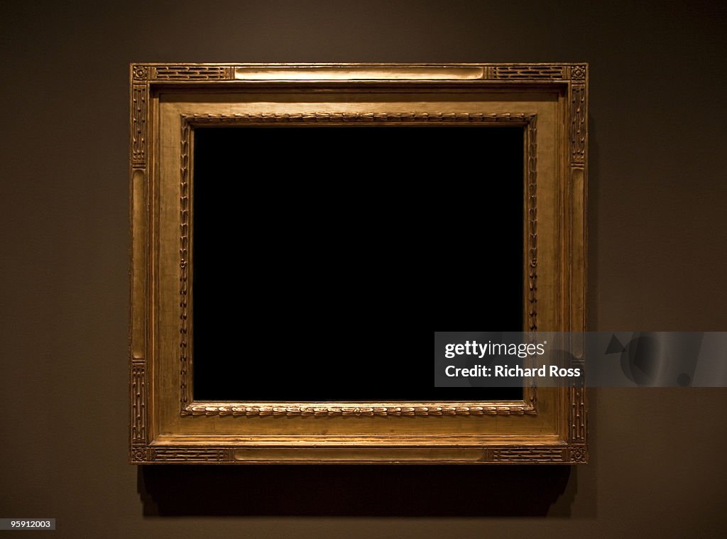 Ornate Gold Frame on a Brown Wall