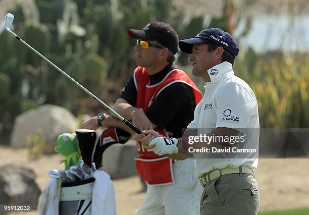 Steve Webster of England watches his second shot at the par 5, 18th hole during the first round of The Abu Dhabi Golf Championship at Abu Dhabi Golf...