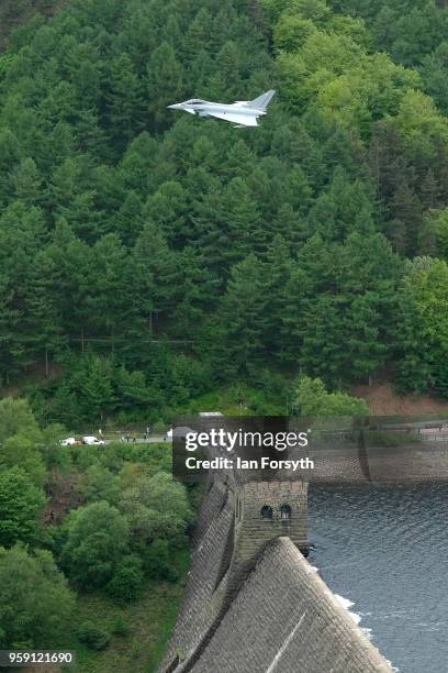 An RAF Typhoon flies over the Derwent Dam in the Upper Derwent Valley on May 16, 2018 in Sheffield, England. The Typhoon replaced a planned flight by...