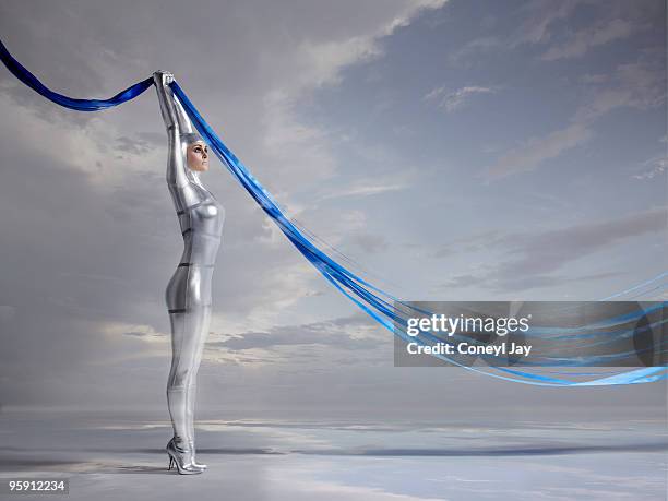 futuristic woman holding blue glowing lines - coneyl - fotografias e filmes do acervo