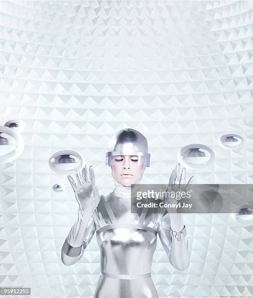 futuristic woman in haptic feedback chamber - monocromo vestimenta fotografías e imágenes de stock