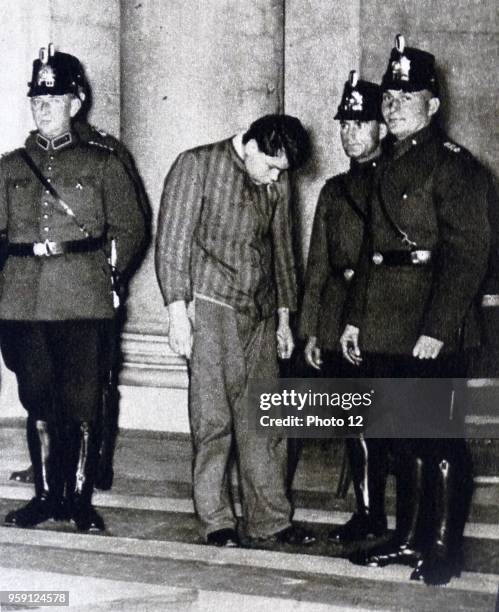 Photographic print of Marinus van der Lubbe with police officers outside of the court. Marinus van der Lubbe, a Dutch council communist who was...