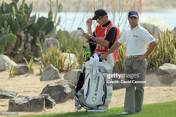 Steve Webster of England waits to play his second shot at the par 5, 18th hole during the first round of The Abu Dhabi Golf Championship at Abu Dhabi...