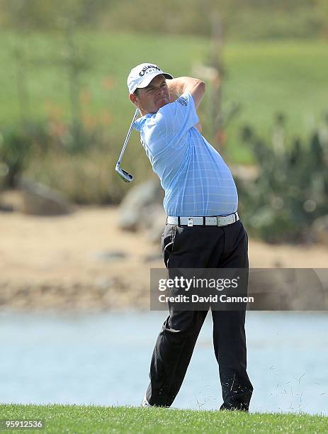 David Drysdale of Scotland plays his second shot at the par 4, 9th hole during the first round of The Abu Dhabi Golf Championship at Abu Dhabi Golf...