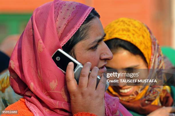 Kashmiri woman speaks on a cell phone in Srinagar on January 21, 2010. India revoked a ban on pre-paid mobile telephones in Kashmir after authorities...