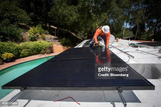 PetersenDean Inc. Employee installs solar panels on the roof of a home in Lafayette, California became the first state in the U.S. To require solar...