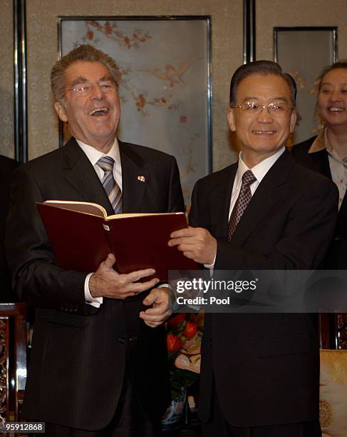 Austrian President Heinz Fischer shows his diary to China's Premier Wen Jiabao before a dinner reception at Diaoyutai State Guest House on January...