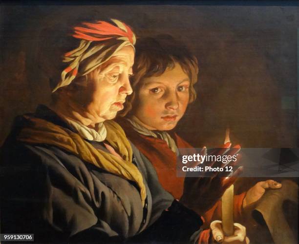 Painting titled 'An Old Woman and a Boy by Candlelight' by Matthias Stom Dutch golden age painter. Dated 17th Century.