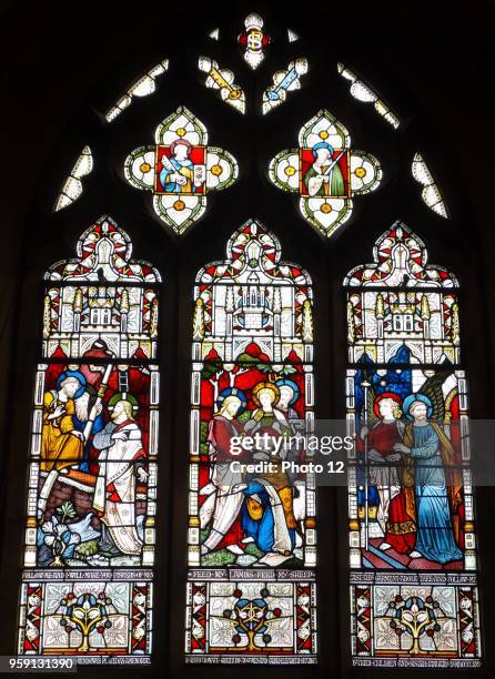 Stained glass window at St Michael and All Angels Anglican church, in Hughenden, Buckinghamshire, England. The window depicts scenes from the life of...