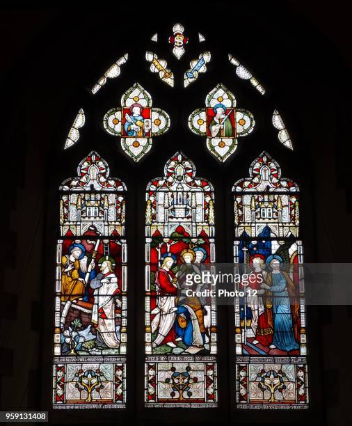 Stained glass window at St Michael and All Angels Anglican church, in Hughenden, Buckinghamshire, England. The window depicts scenes from the life of...