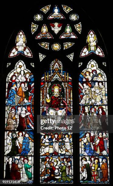 Stained glass window at St Michael and All Angels Anglican church, in Hughenden, Buckinghamshire, England. The window depicts Christ enthroned....