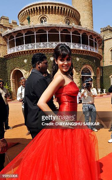 Bollywood actor Genelia D'Souza poses in front of the Bangalore Palace at Virgin Mobiles GSM service launch in Bangalore on January 21, 2010. Virgin...
