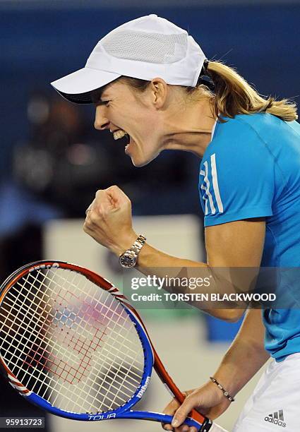 Justine Henin of Belgium celebrates during the second set in her victory over Elena Dementieva of Russia in their women's singles second round match...