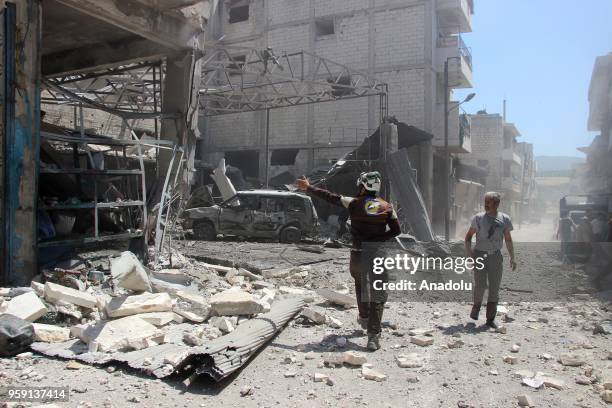 Civil defence crews and locals conduct search and rescue works after airstrikes hit residential areas of Jisr al-Shughur in the northwestern Idlib...