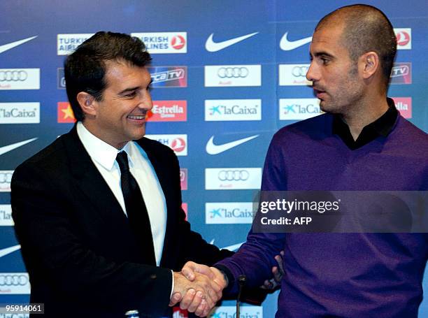 Barcelona's president Joan Laporta and Barcelona's coach Pep Guardiola shake hands before a press conference at the Camp Nou Stadium in Barcelona, on...