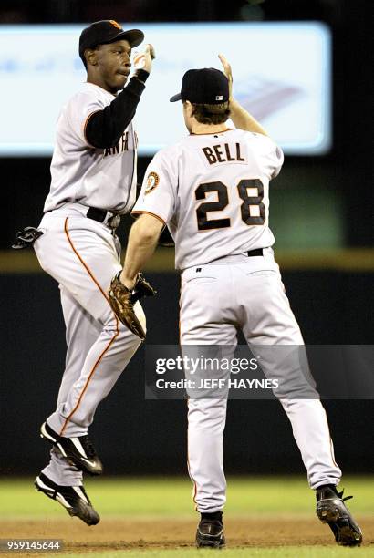 Kenny Lofton of the San Francisco Giants is congratulated by team mate David Bell 09 October after game one of the National League Championship...