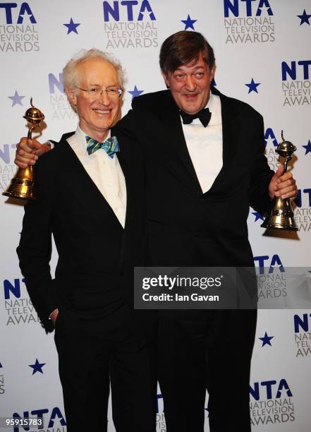 Stephen Fry poses with his Most Popular Documentary award and Special Recognition award with presenter Bamber Gascoigne at the National Television...