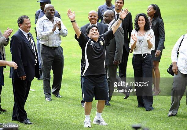 Argentinian soccer head coach Diego Maradona flanked by 2010 Organising Committee CEO Danny Jordaan greets workers in Soccer City Stadium on January...