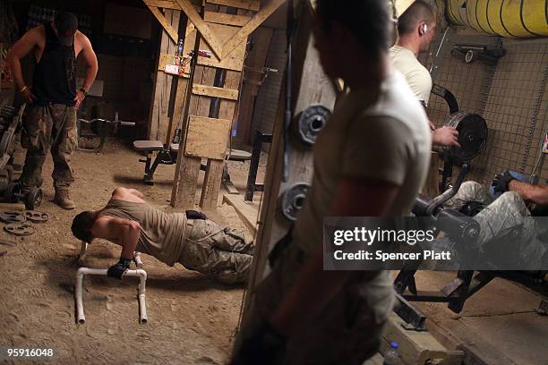 Soldiers with US Army Able Company, 3-509 Infantry Battalion work out in the gym at Combat Outpost Zerak on January 21, 2010 in Zerak, Afghanistan....