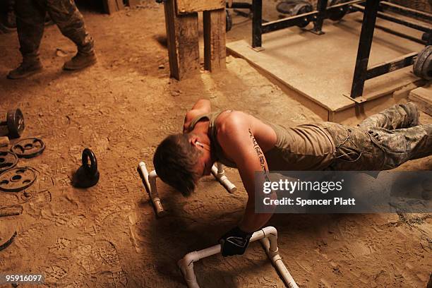 Corp. Nicholas Birkner with the US Army Able Company, 3-509 Infantry Battalion and of Fairview Heights, Illinois works out in the gym at Combat...