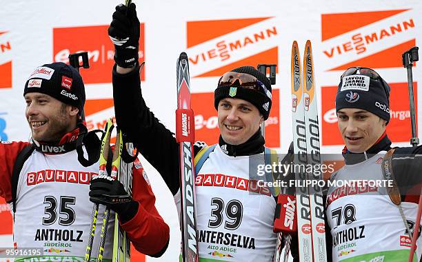 Ukranian Serguei Sednev celebrates his first place flancked by Austrian Daniel Mesotitsch, second, and third placed Frenchman Alexis Boeuf on the...