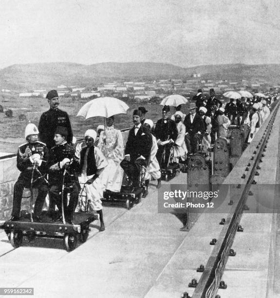 For the inauguration of the Aswan dam, Duke von Connaught and viceroy Abbas II Hilmi cross the dam with trolleys, 1902.