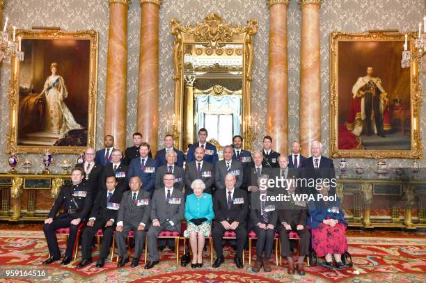 Queen Elizabeth II poses for a group photo with holders of the Victoria and George Cross medals, Sgt Johnson Beharry VC, Cpl Joshua Leakey VC, Mr...