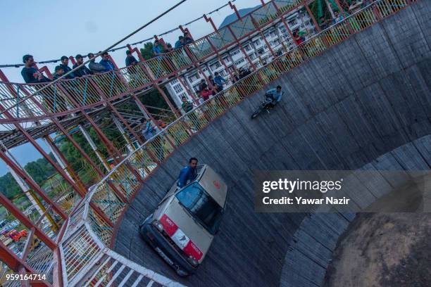 Stunt driver and motorcyclist daredevils perform in the well of death on May 15, 2018 in Srinagar, the summer capital of Indian administered Kashmir,...