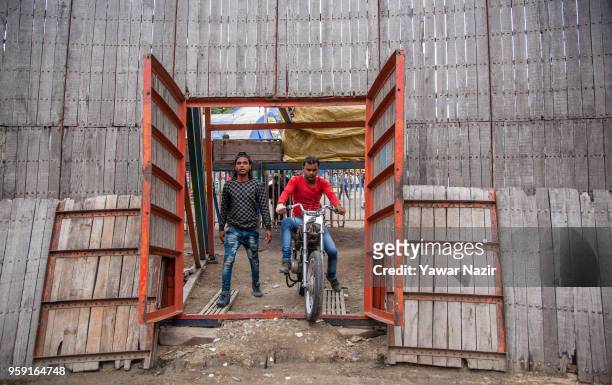 Stunt motorcyclist daredevil enters the arena before performing in the well of death on May 15, 2018 in Srinagar, the summer capital of Indian...