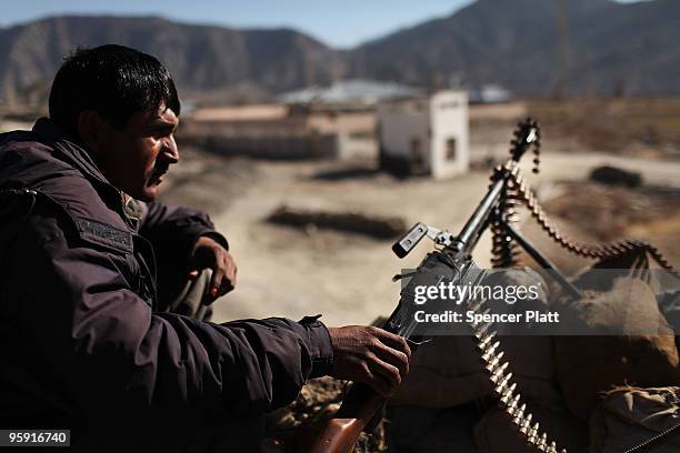 Member of the Afghan National Police keeps watch outside of the district center beside Combat Outpost Zerak on January 21, 2010 in Zerak,...