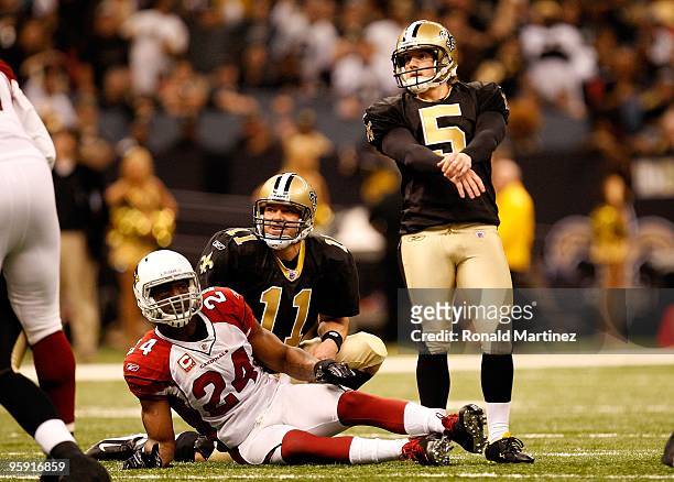 Kicker Garrett Hartley and holder Mark Brunell of the New Orleans Saints watch the flight of Hartley's successful kick against Adrian Wilson of the...