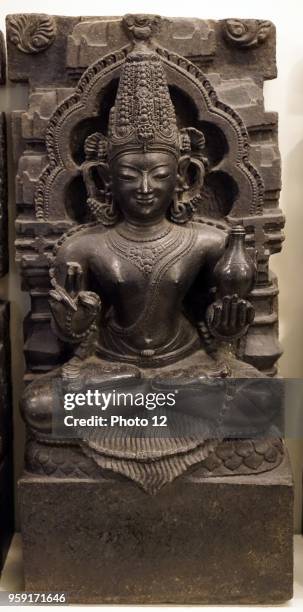 Sculpture of the Indian planet of the Mars holding a water pot in one hand and prayer beads in another. Dated 17th Century.