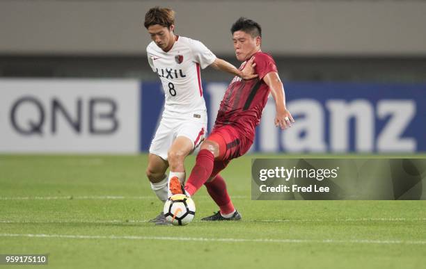 Cai huikang of Shanghai SIPG and Shoma Doi of Kashima Antlers in action during the AFC Champions League Round of 16 match between Shanghai SIPG v...