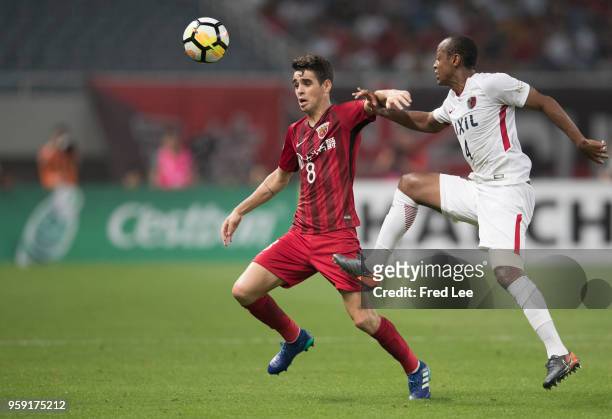 Oscar of Shanghai SIPG and Leo Silva of Kashima Antlers in action during the AFC Champions League Round of 16 match between Shanghai SIPG v Kashima...