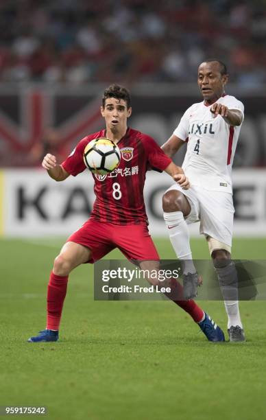 Oscar of Shanghai SIPG and Leo Silva of Kashima Antlers in action during the AFC Champions League Round of 16 match between Shanghai SIPG v Kashima...